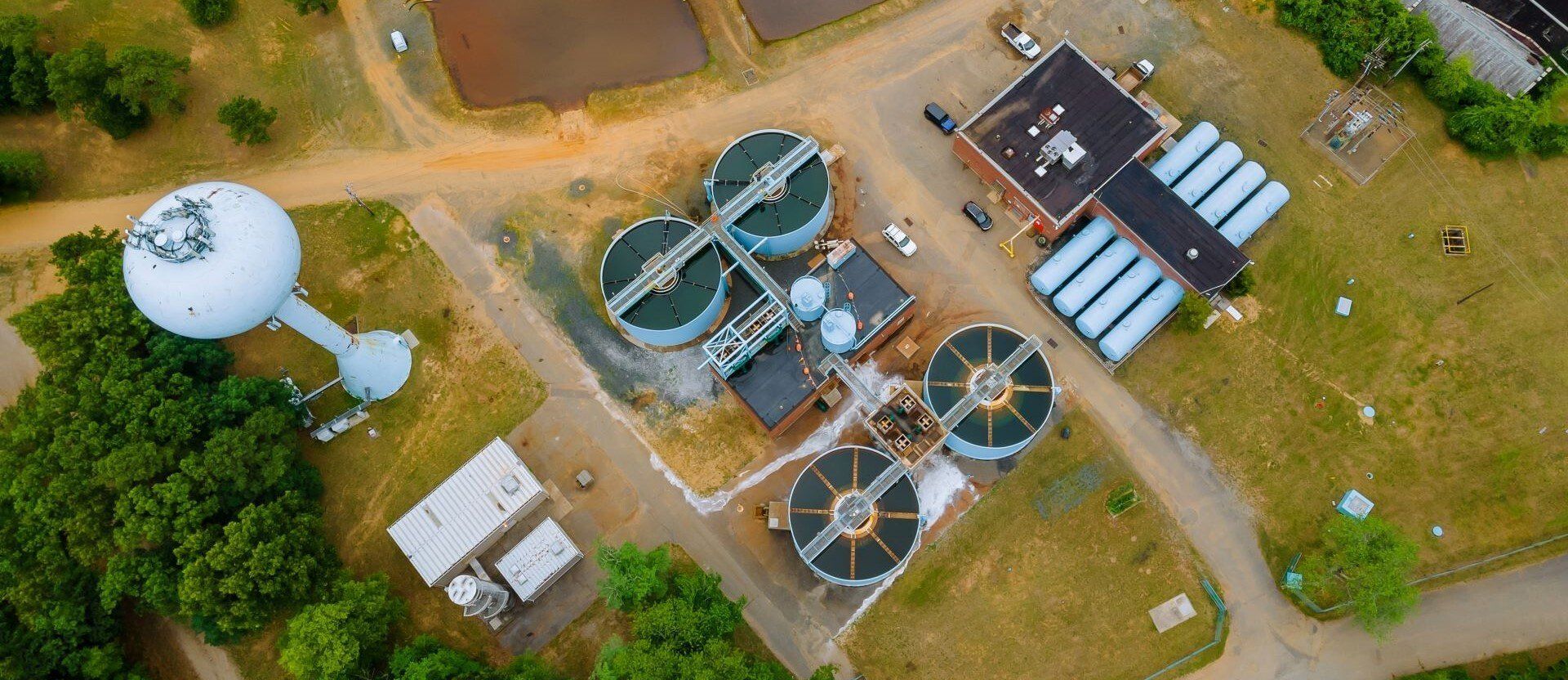 An aerial view of a water treatment plant with a water tower.