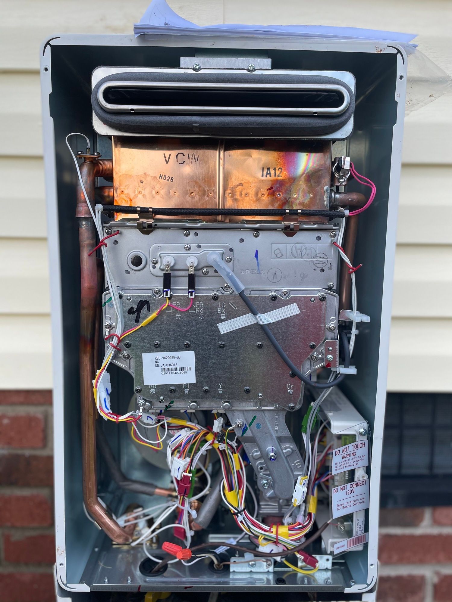 The inside of a water heater is shown with the lid open.