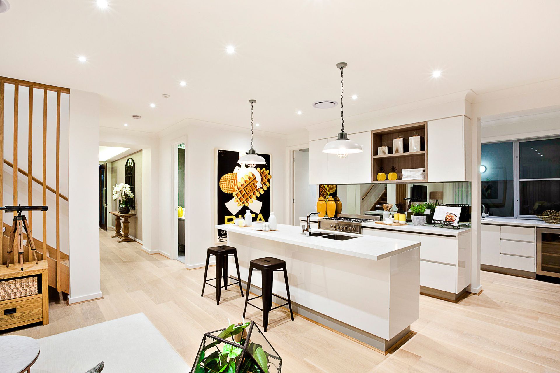 A kitchen with white cabinets and a large island in the middle of the room.