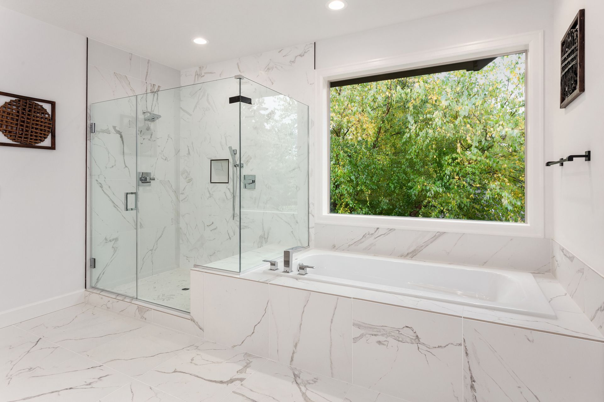 A bathroom with a tub , shower , and window.