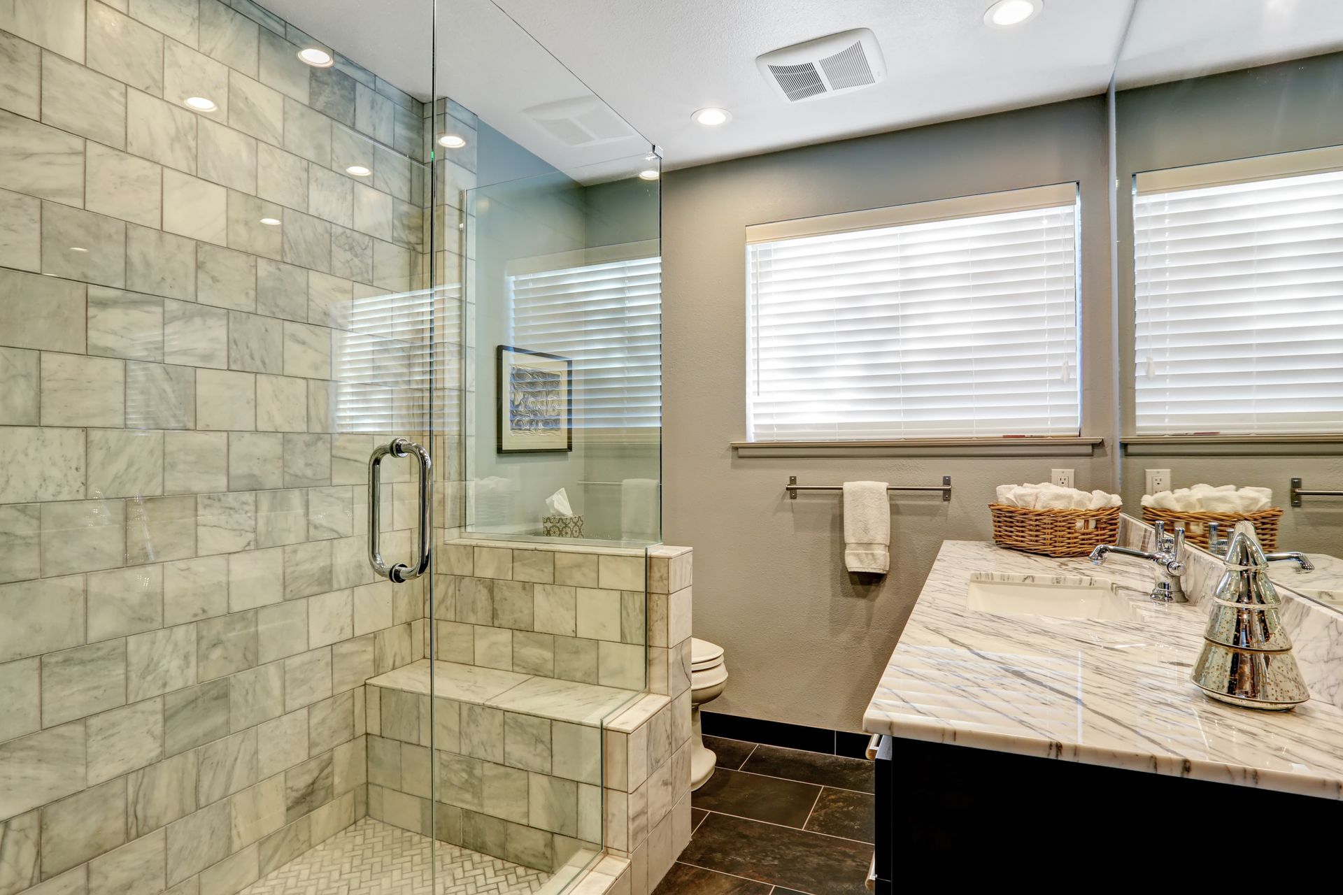 A bathroom with a walk in shower and a sink.