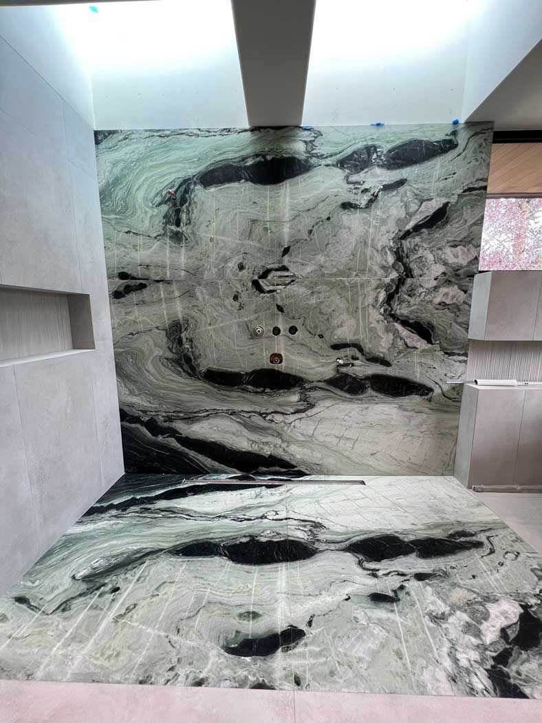 There is a large marble wall in the middle of a room.