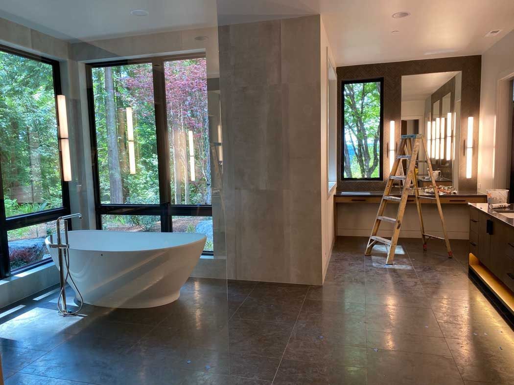 A bathroom with a bathtub and a ladder in it.