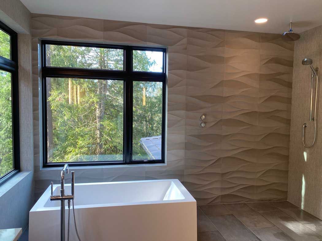 A bathroom with a bathtub and a window