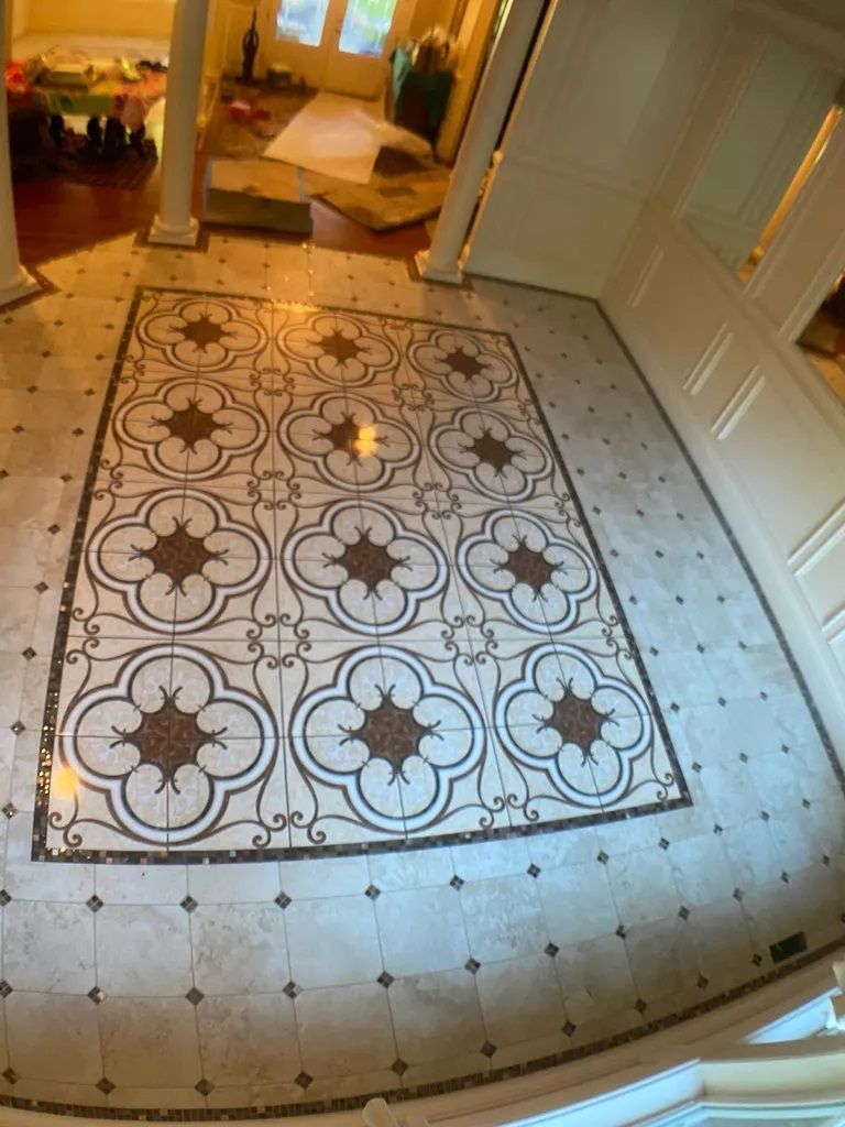 A tiled floor with a floral pattern in a room.