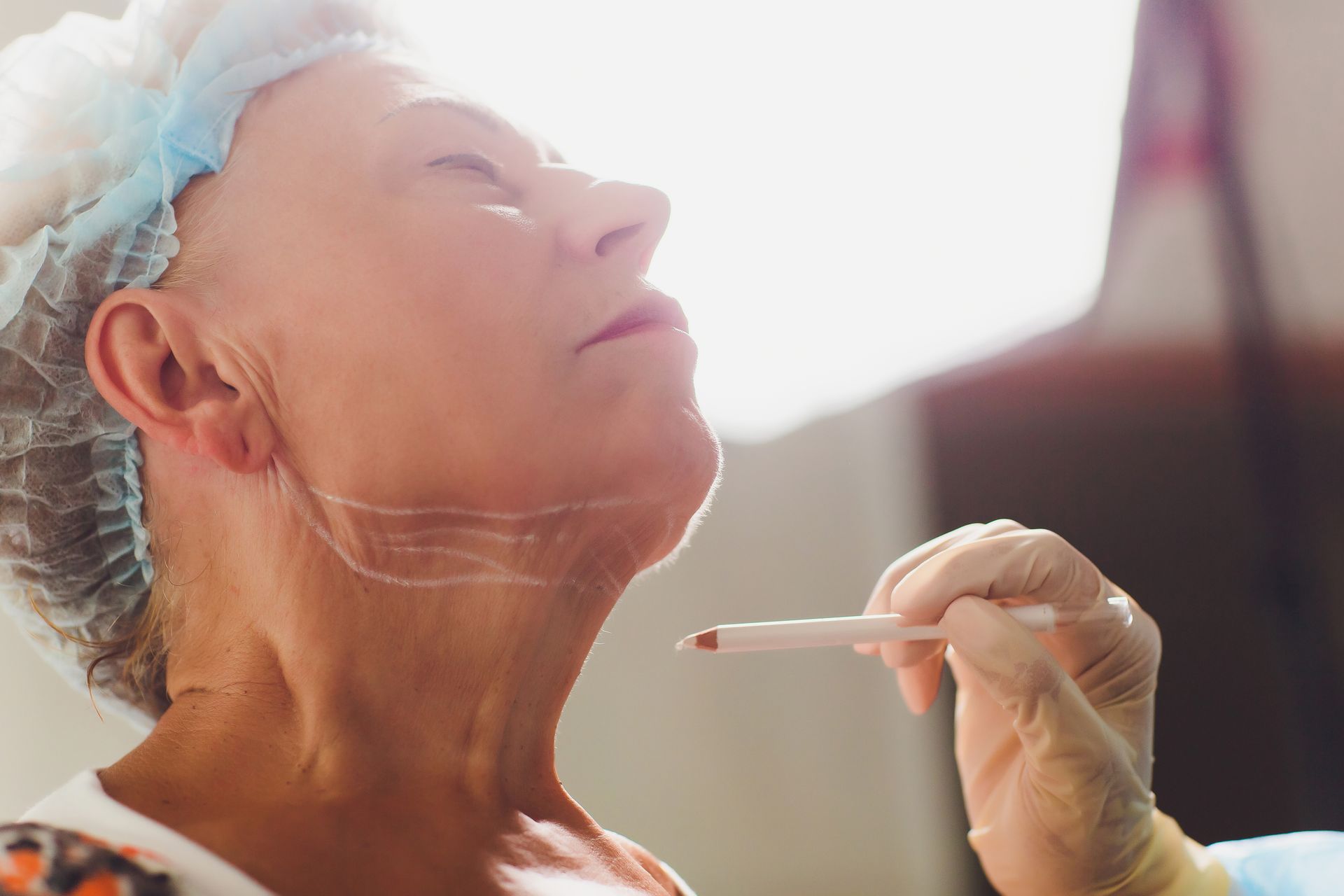 An older woman is getting a surgery on her neck.