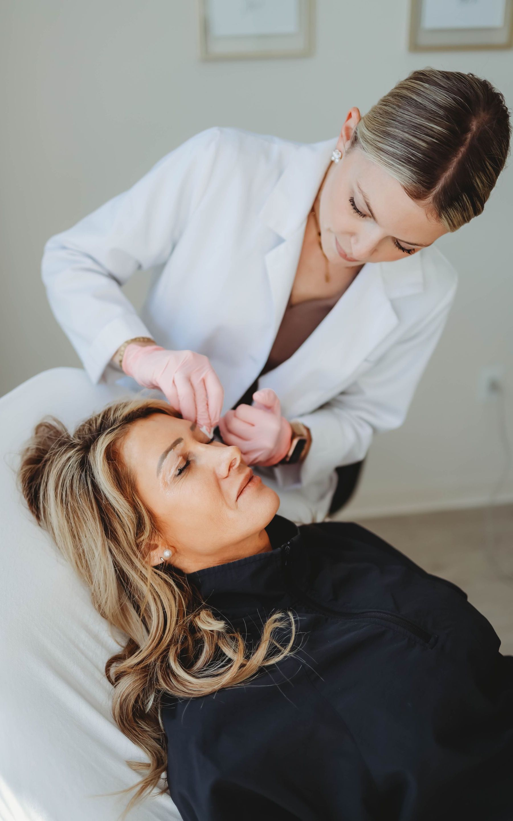 Patient receiving dermaplaning treatment in spa