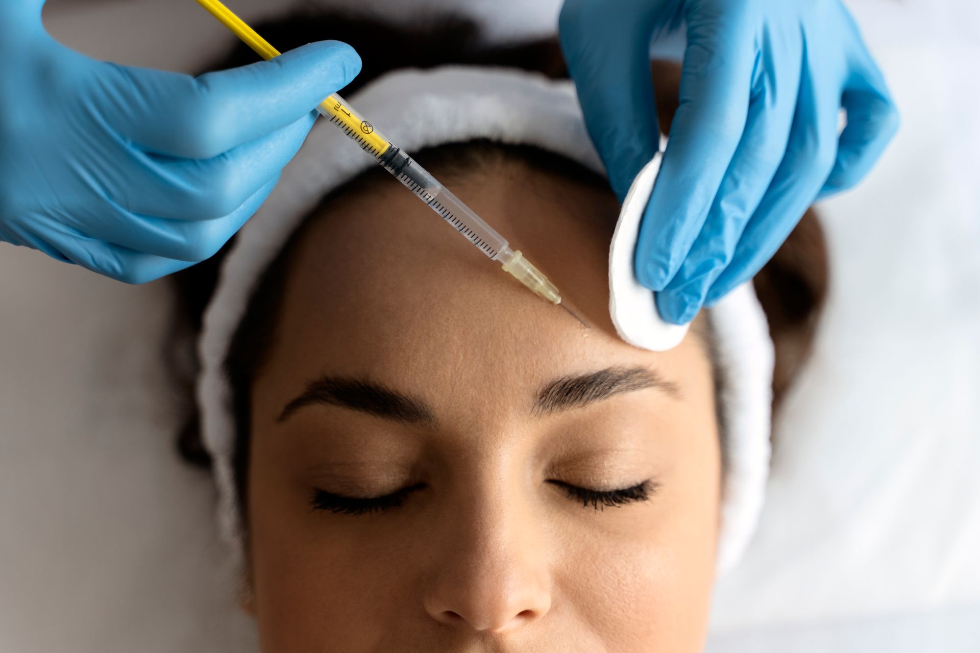 Woman getting face treatment