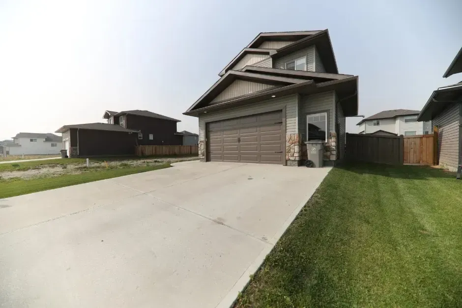 Residential home with a newly repaired concrete driveway, ensuring durability and long-lasting foundation support.