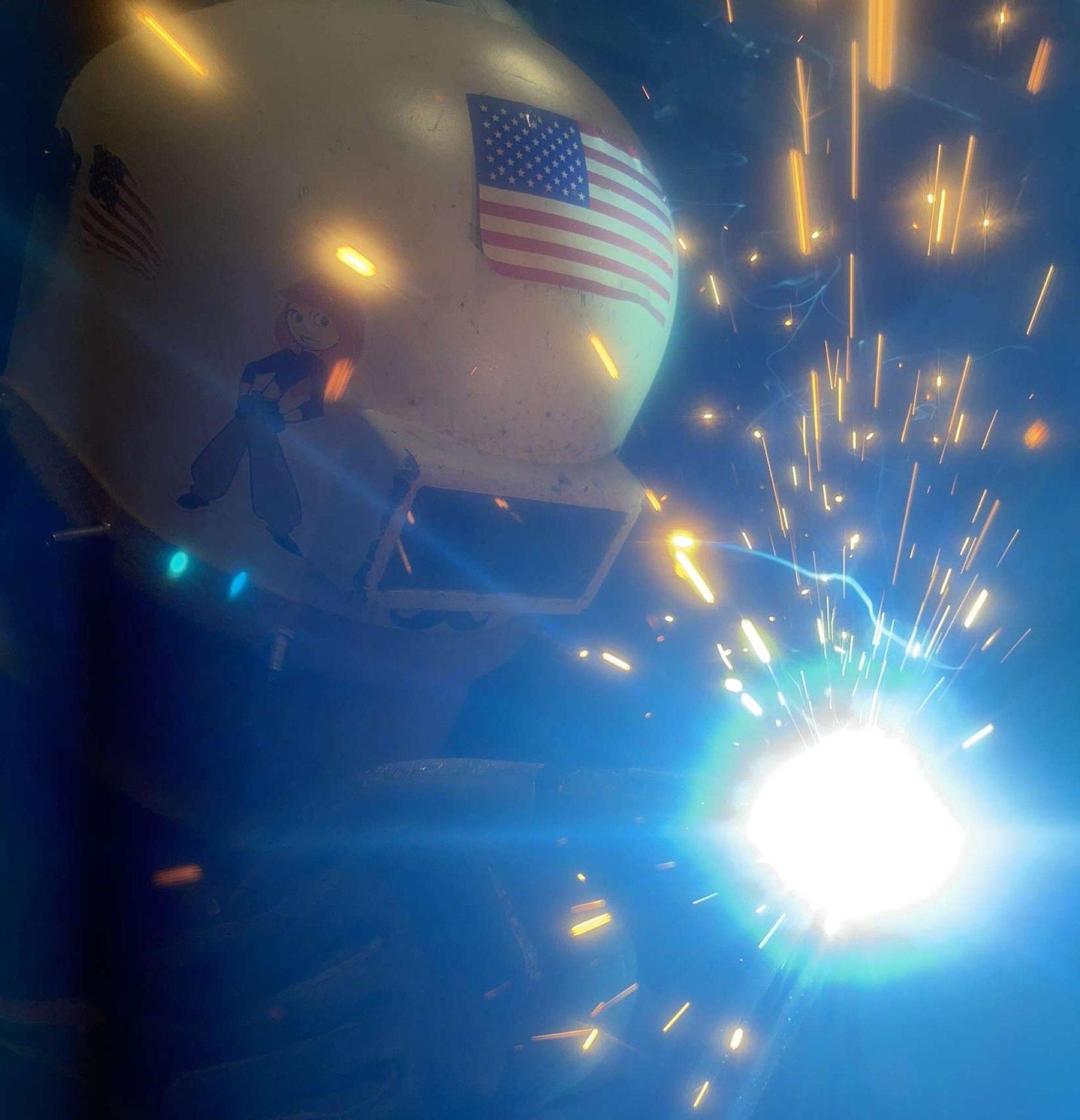 A welding helmet with an american flag on it