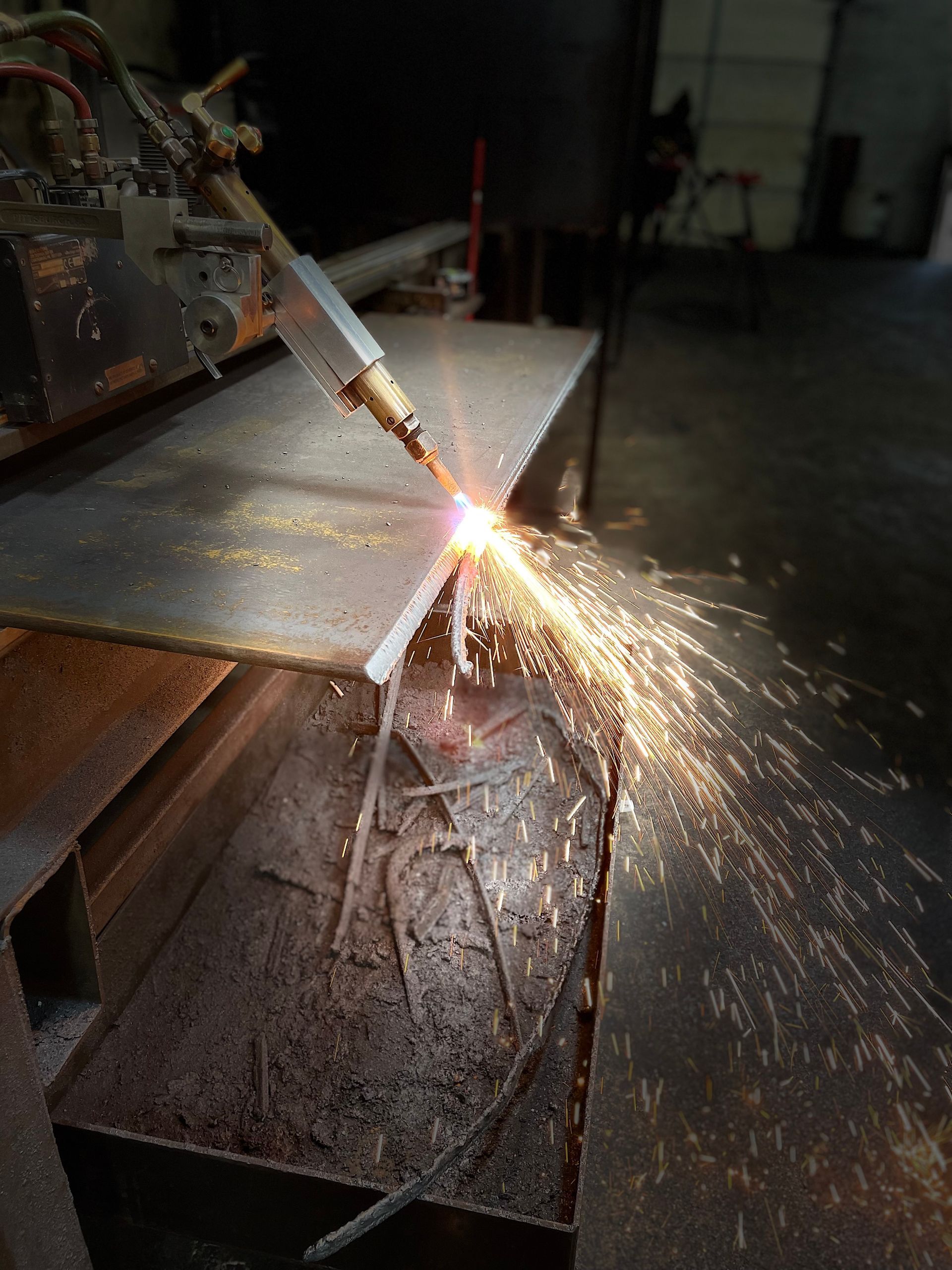 A person is cutting a piece of metal with a torch.