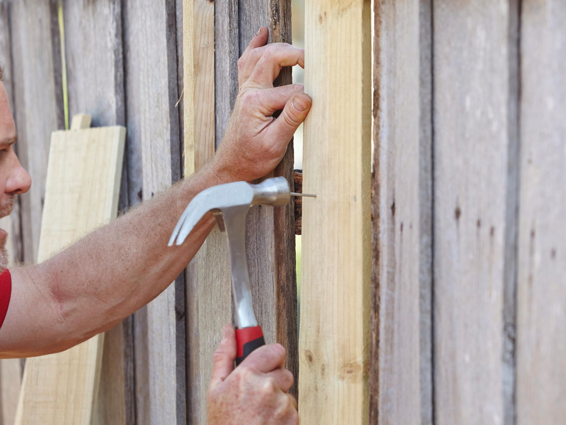 An experienced handyman skillfully repairing and installing tiles, carefully aligning and leveling each piece to create a seamless and attractive surface.