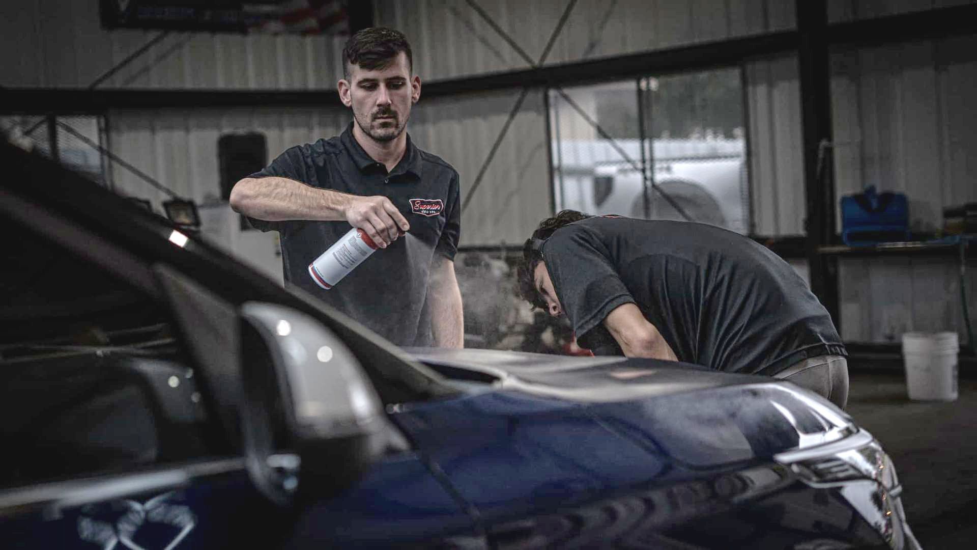 A black harley davidson motorcycle is parked in a garage.