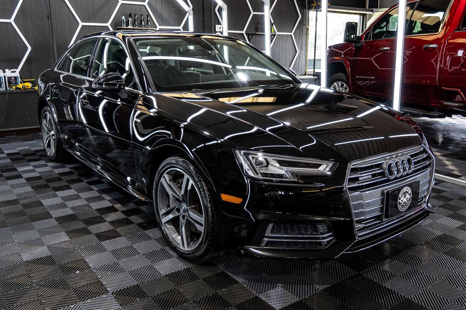 A black audi a4 is parked in a garage.
