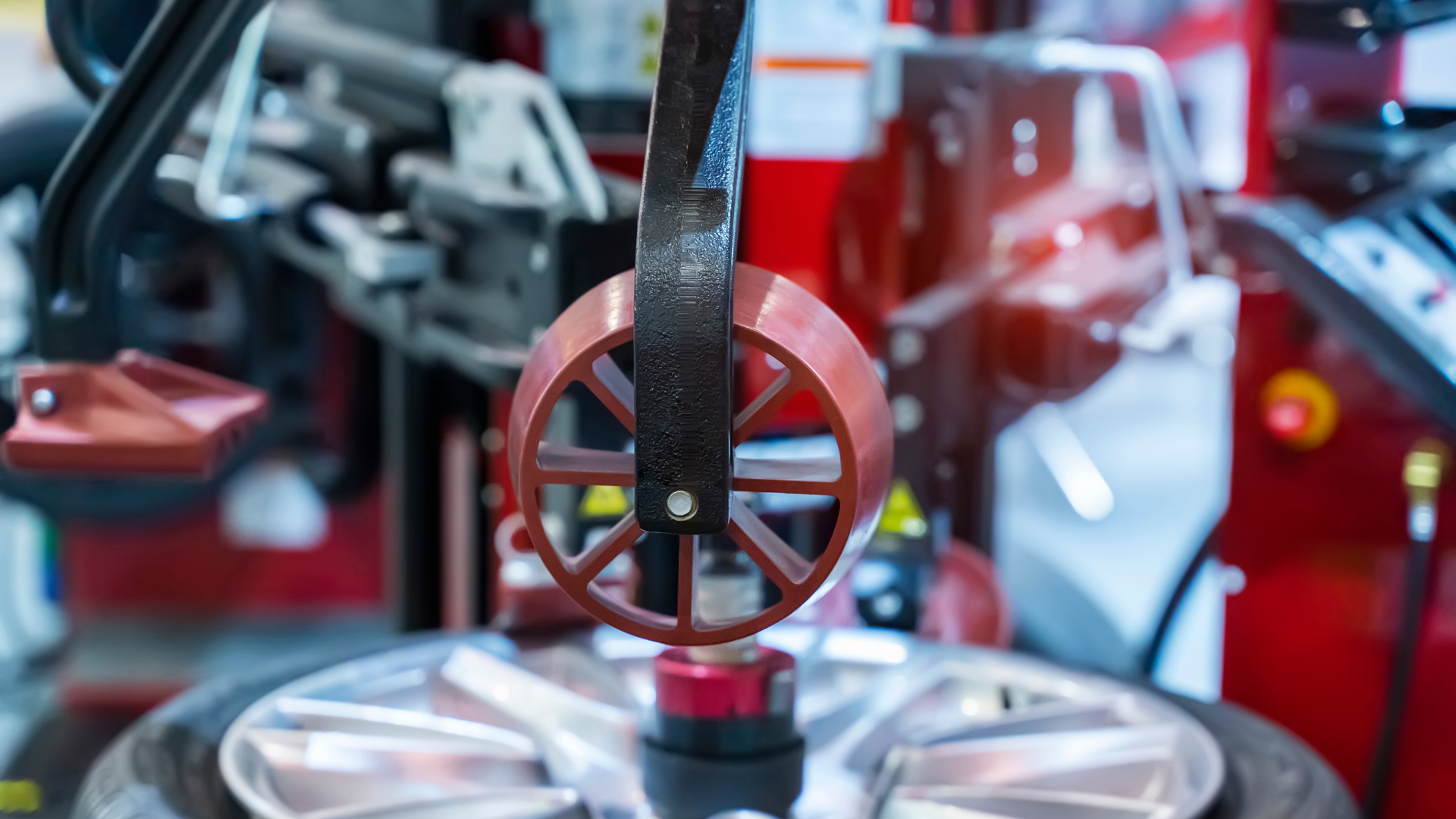 A close up of the underside of a car with a shock absorber and a wheel.