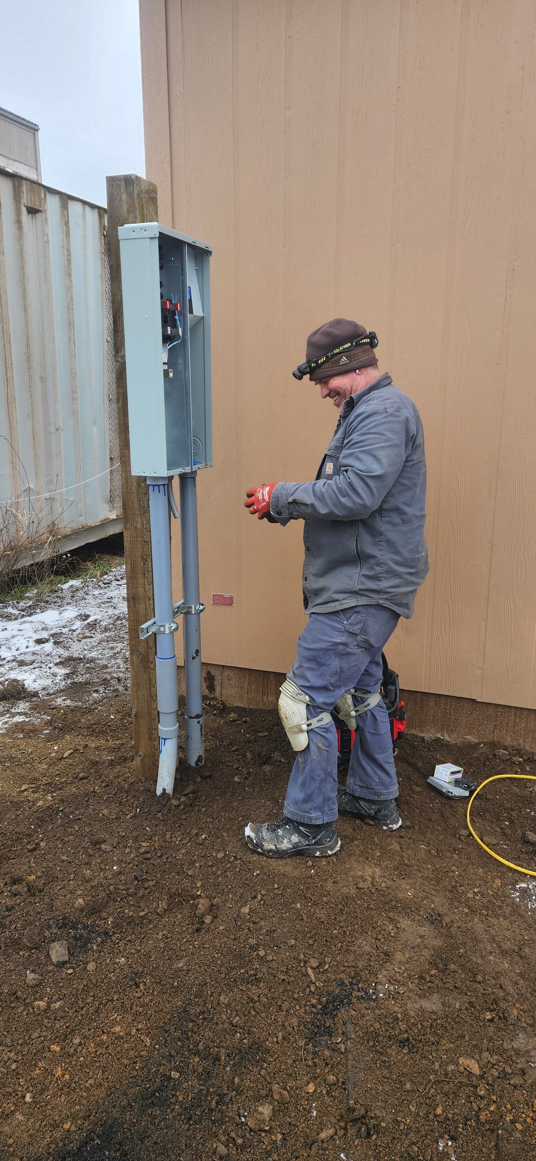 A woman is pressing a button on a security system.
