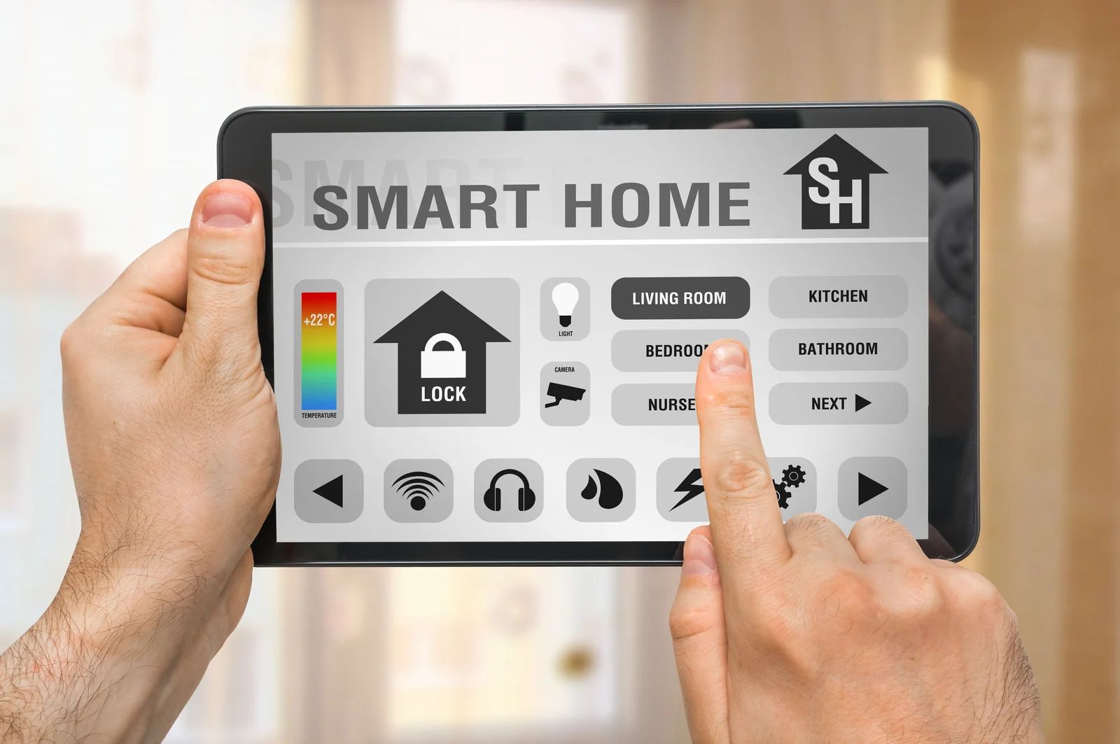 Hands holding a tablet displaying a smart home interface with touch controls, icons, and text.