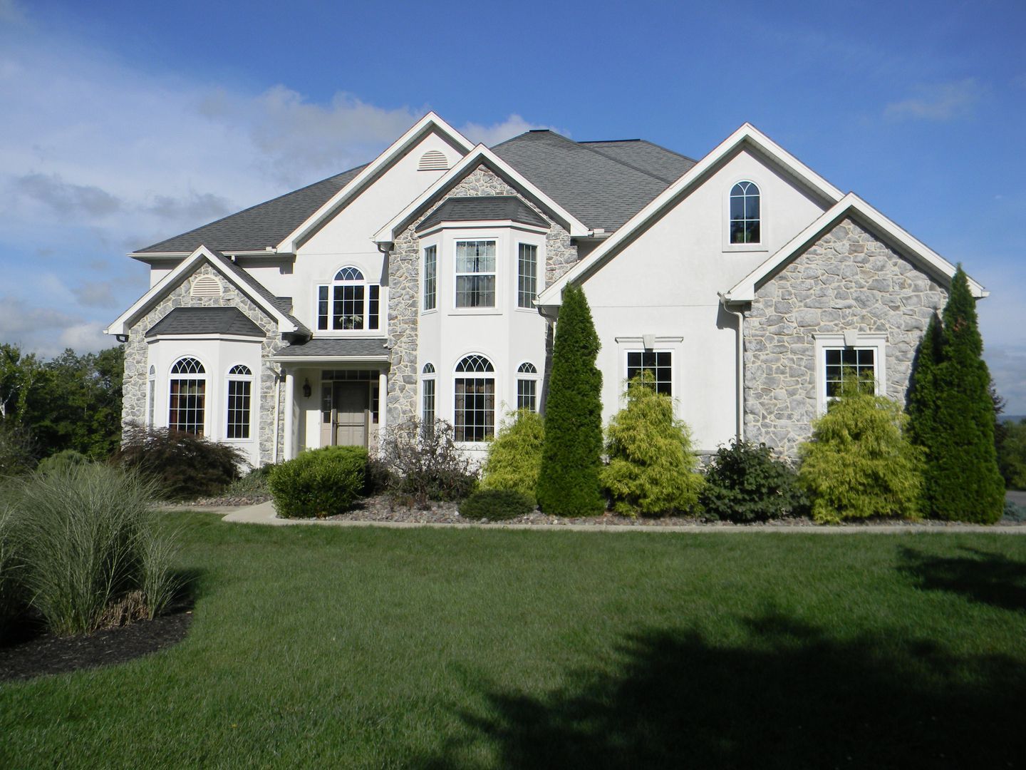A large white house with a gray roof
