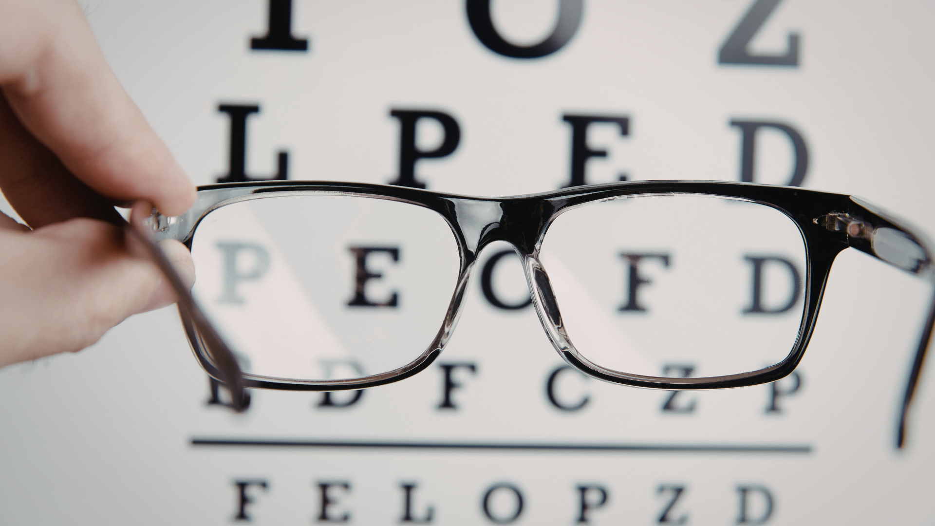 A close up of a woman 's eye with mascara and freckles.