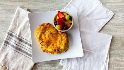 Omelet with Mushrooms and Green Onions on a White Plate - Round Lake, IL - Eggspress Cafe