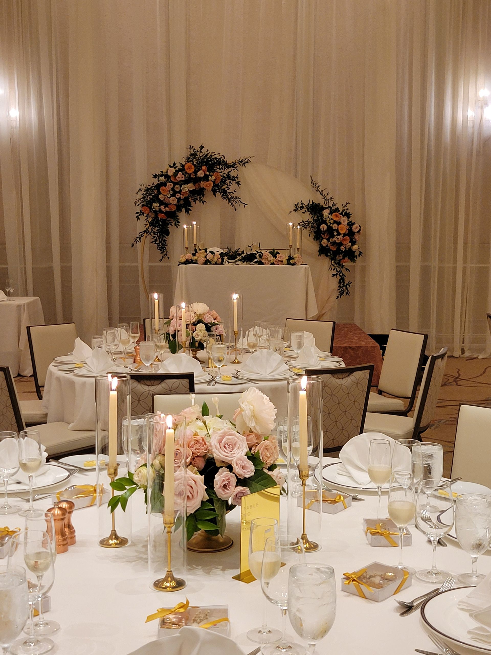 A table set for a wedding reception with flowers and candles