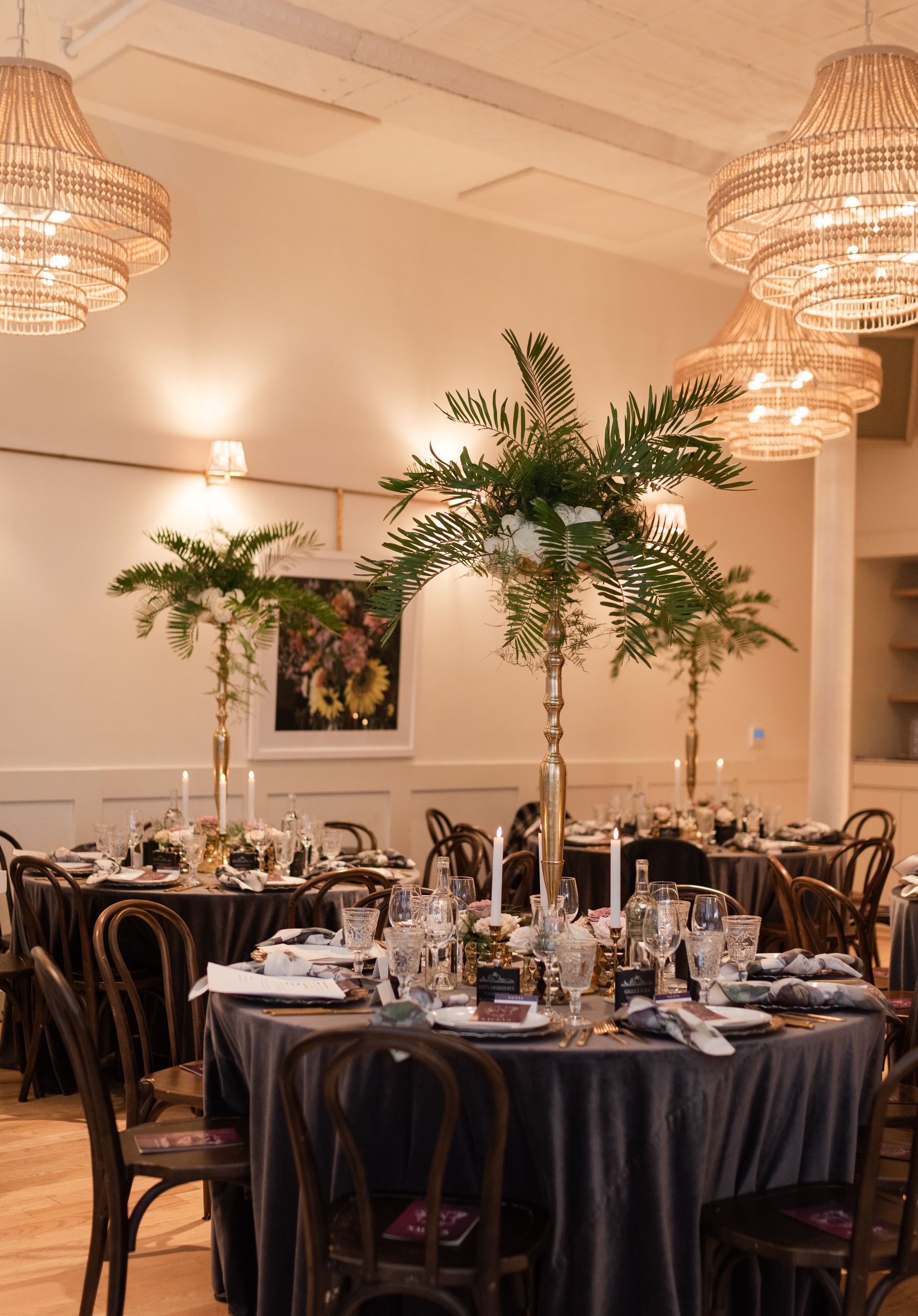 A room with tables and chairs set up for a wedding reception.