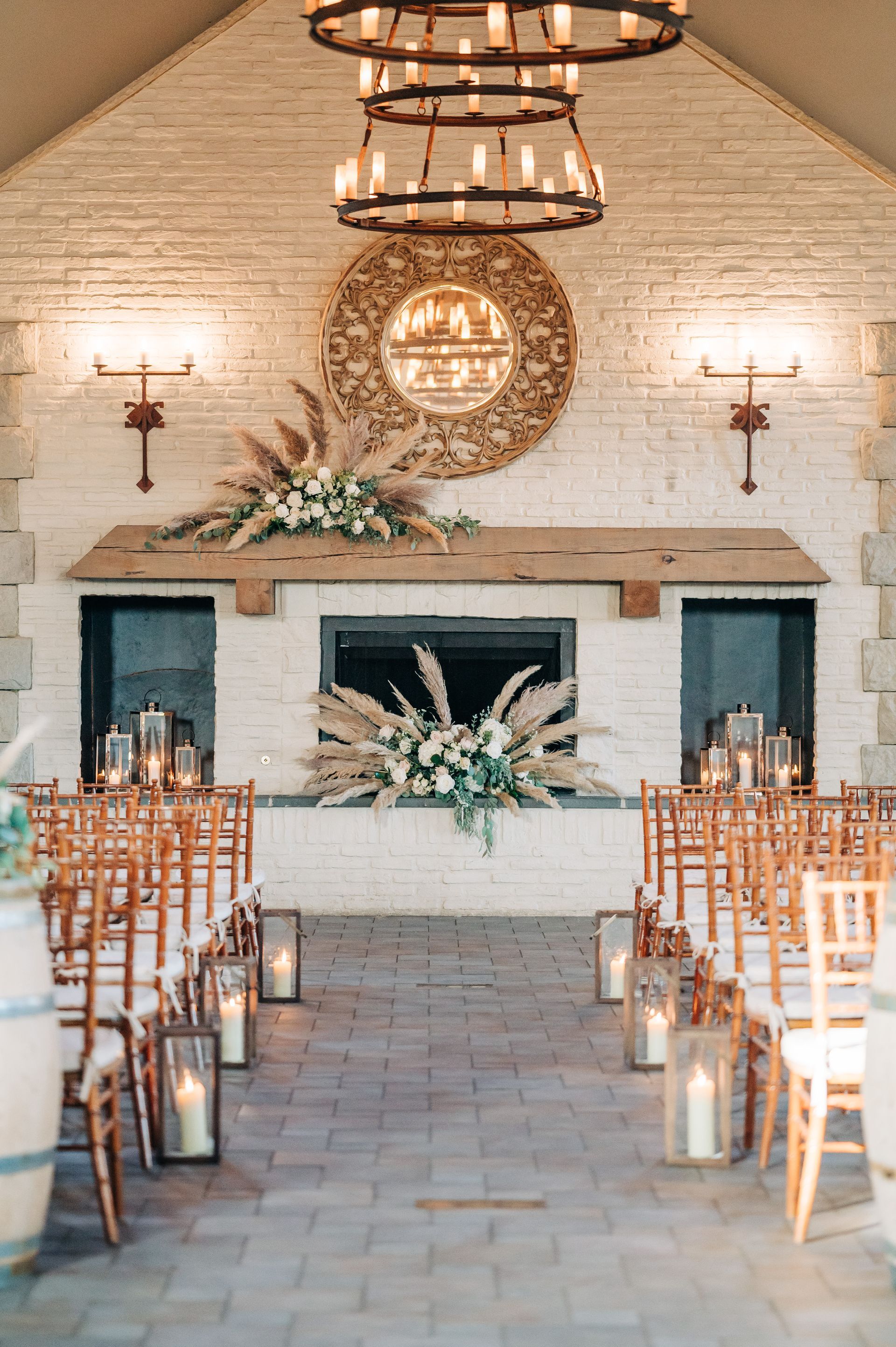 A wedding ceremony is taking place in a room with a fireplace and candles.