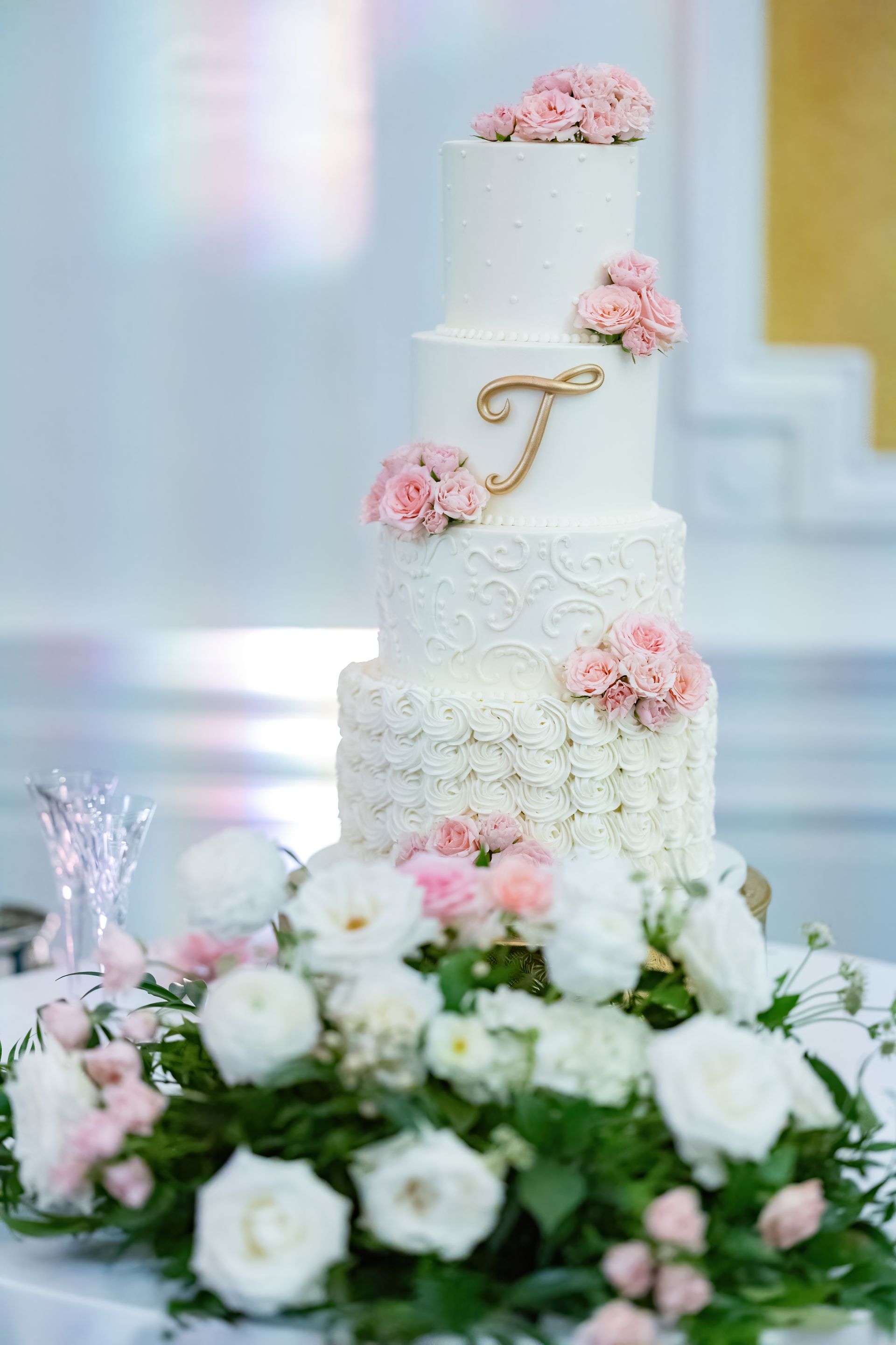 A wedding cake is sitting on top of a table surrounded by flowers.