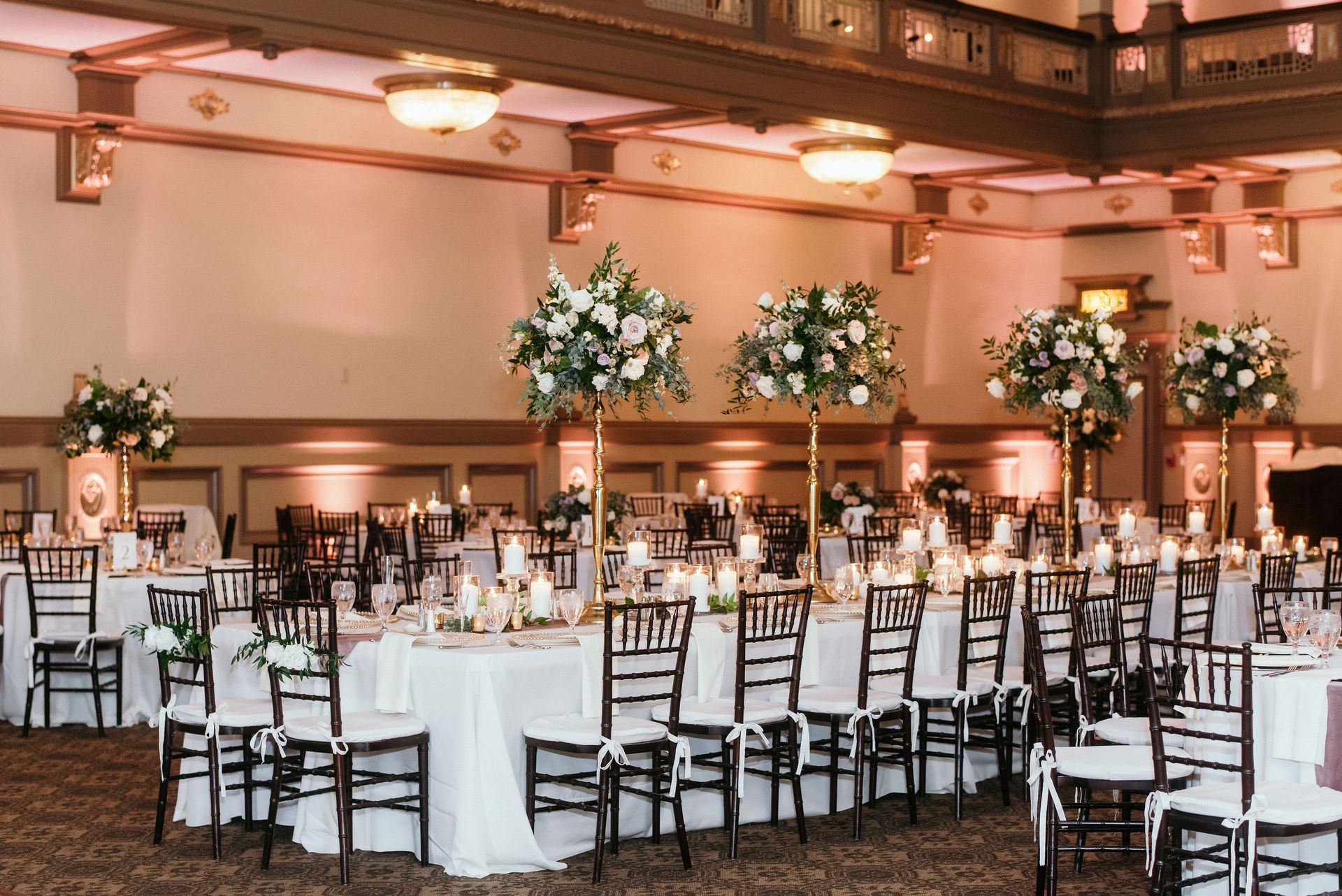 A large room with tables and chairs set up for a wedding reception.