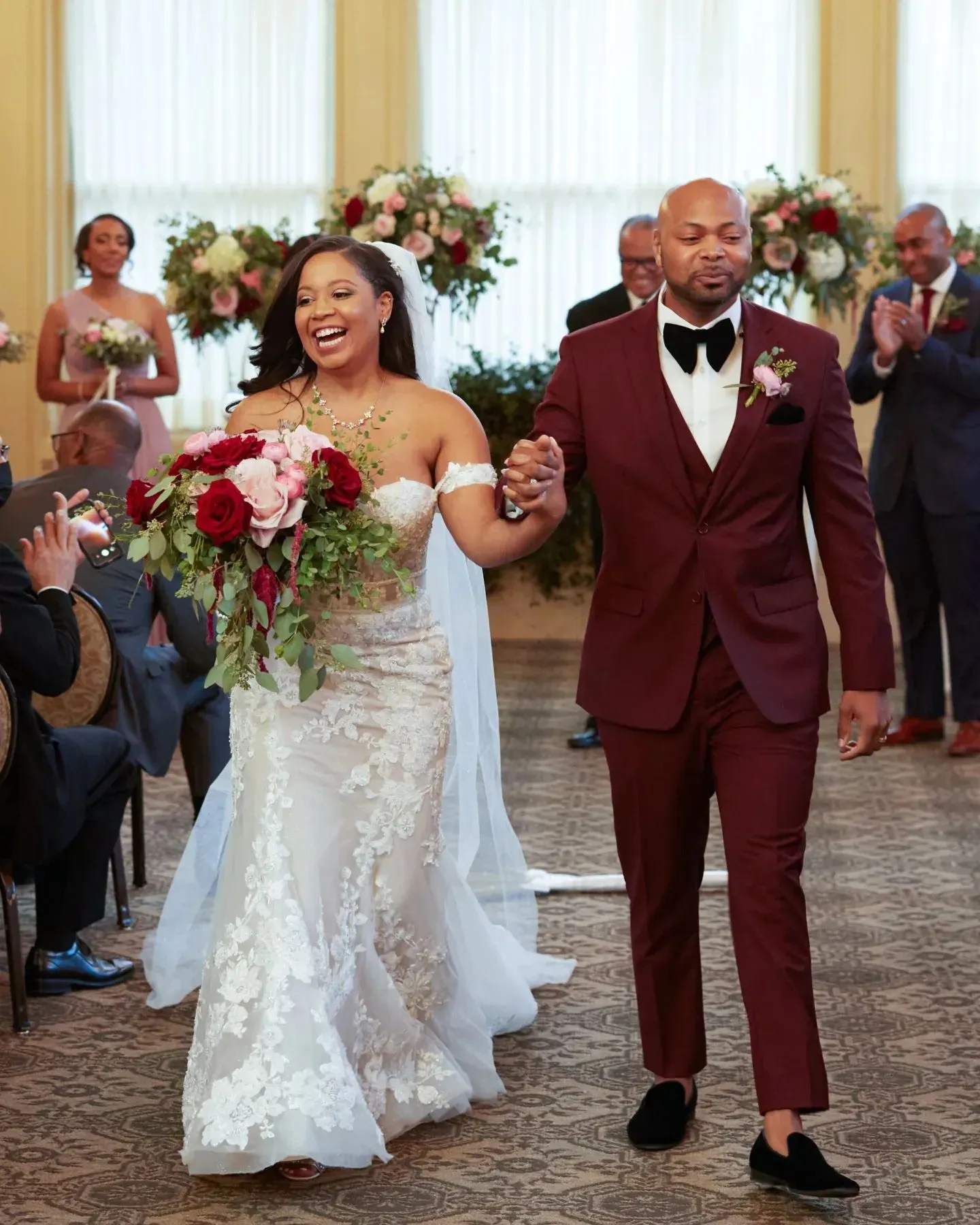 A bride and groom are walking down the aisle at their wedding.