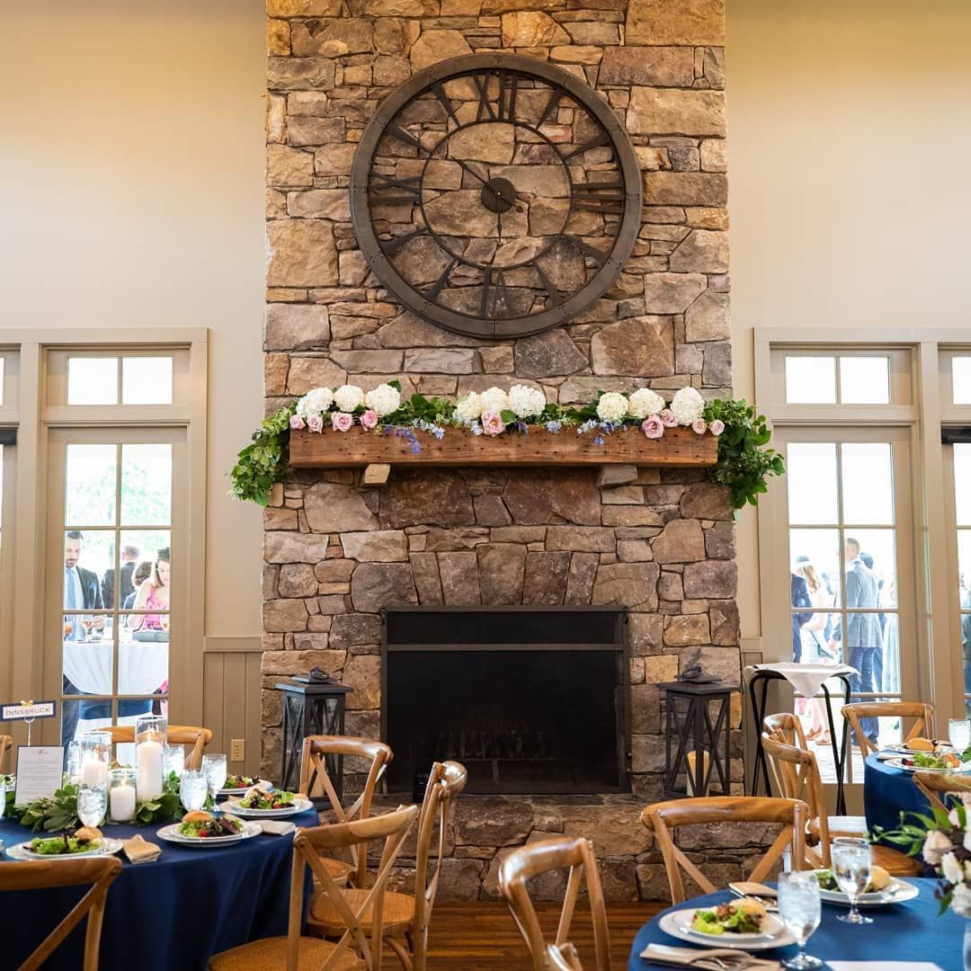 A large stone fireplace with a clock above it