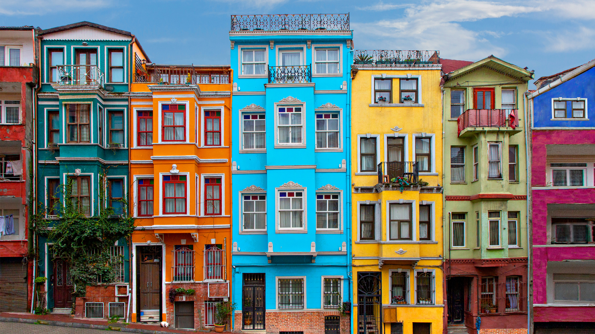 A row of colorful buildings are lined up in a row.