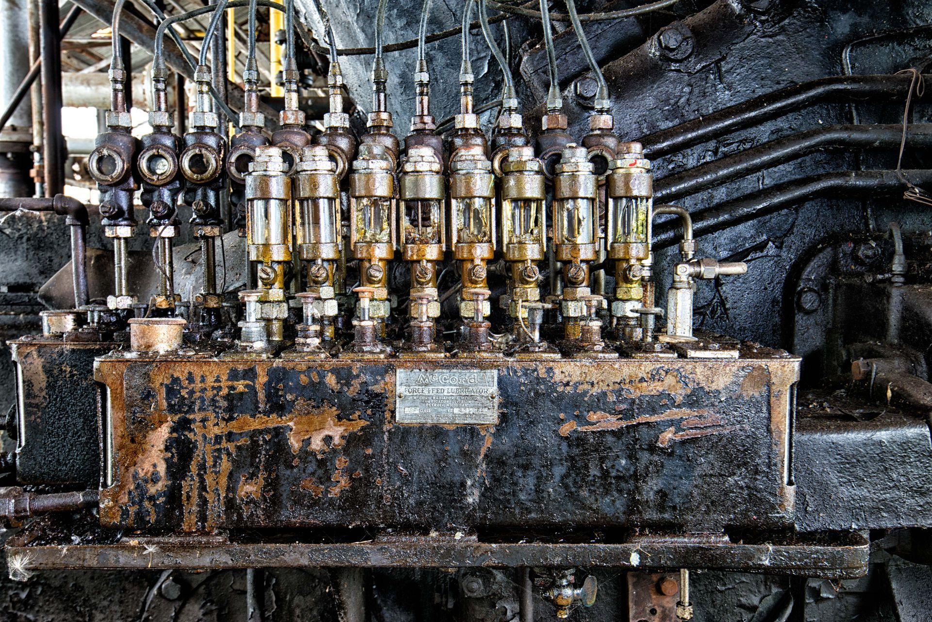 Close-up of old industrial machinery, covered in grime and oil.