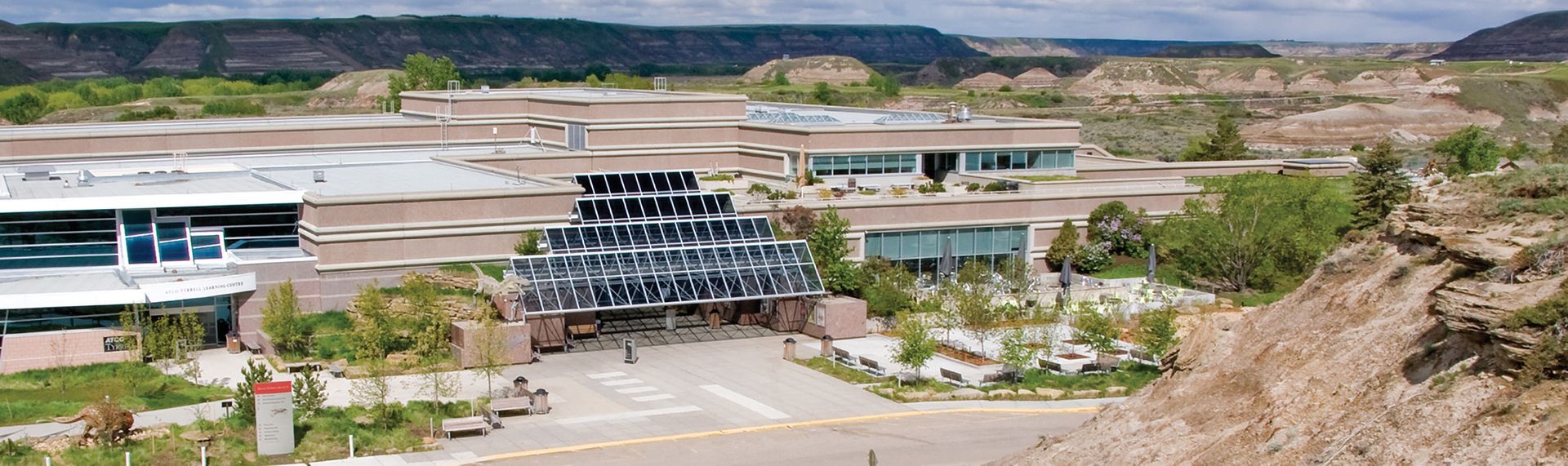 A building with a solar panel entrance in a desert landscape.