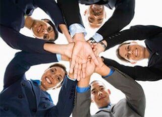 Business people in huddle - Management Houston, TX