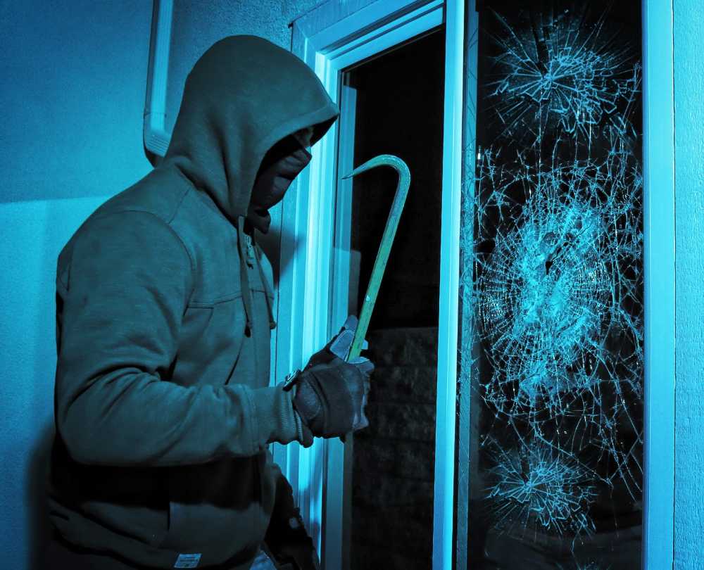 Burglar Breaking Glass Door — Premium Window Films in South Lismore, NSW