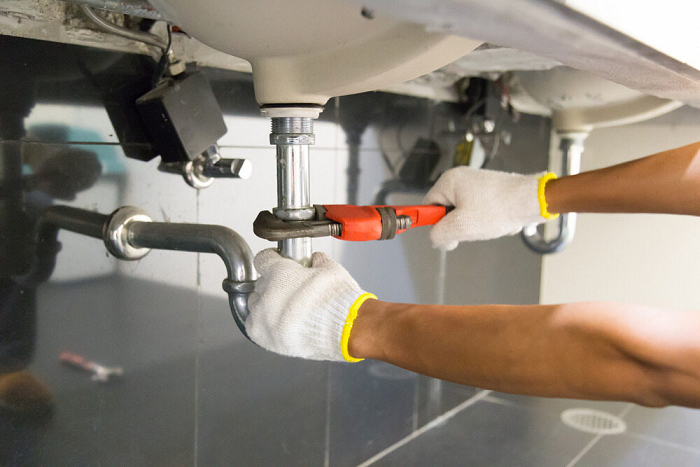 plumber fixing a drain