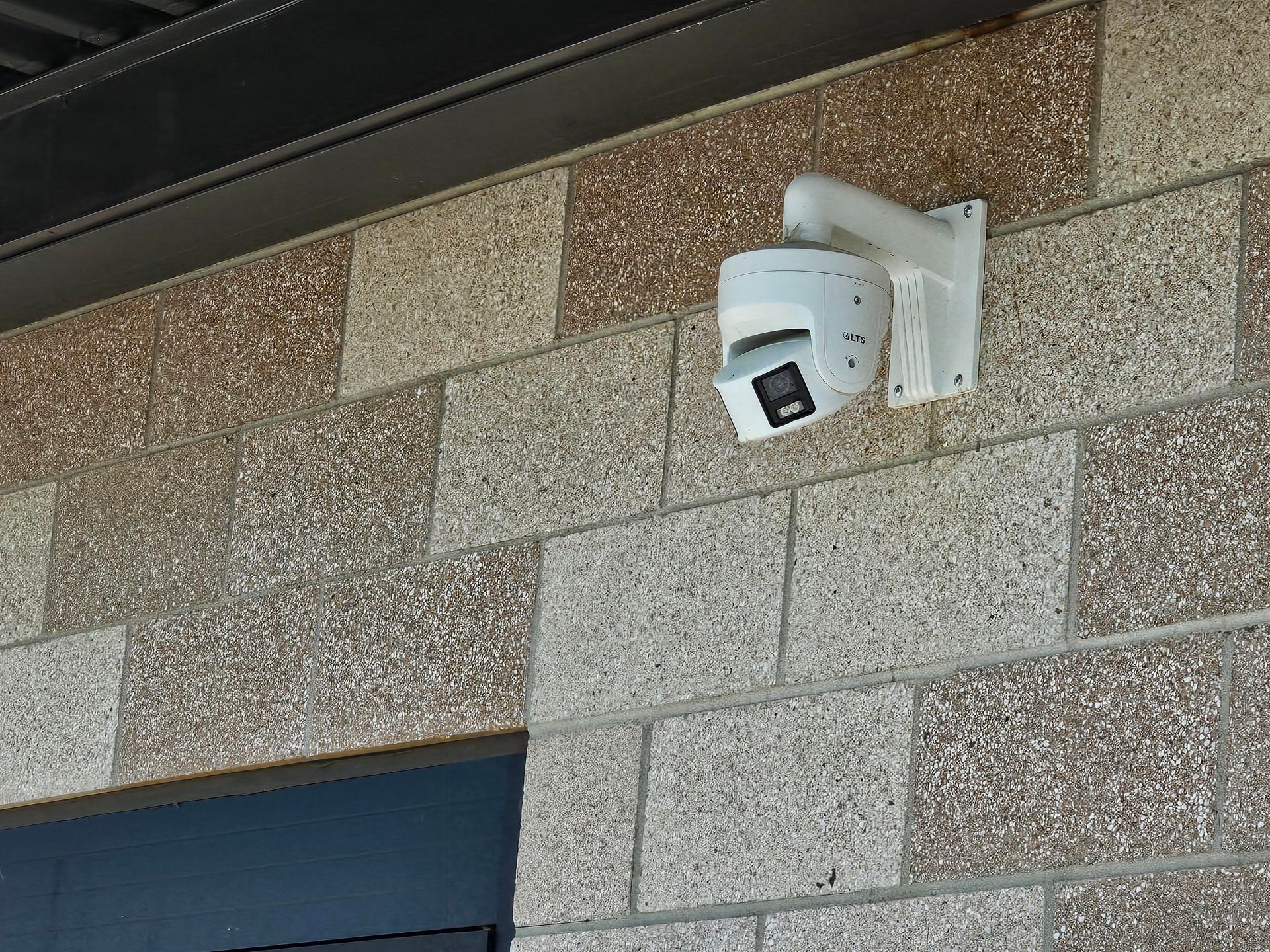 Network and electrical equipment mounted on wooden wall. Cables and conduits are visible.