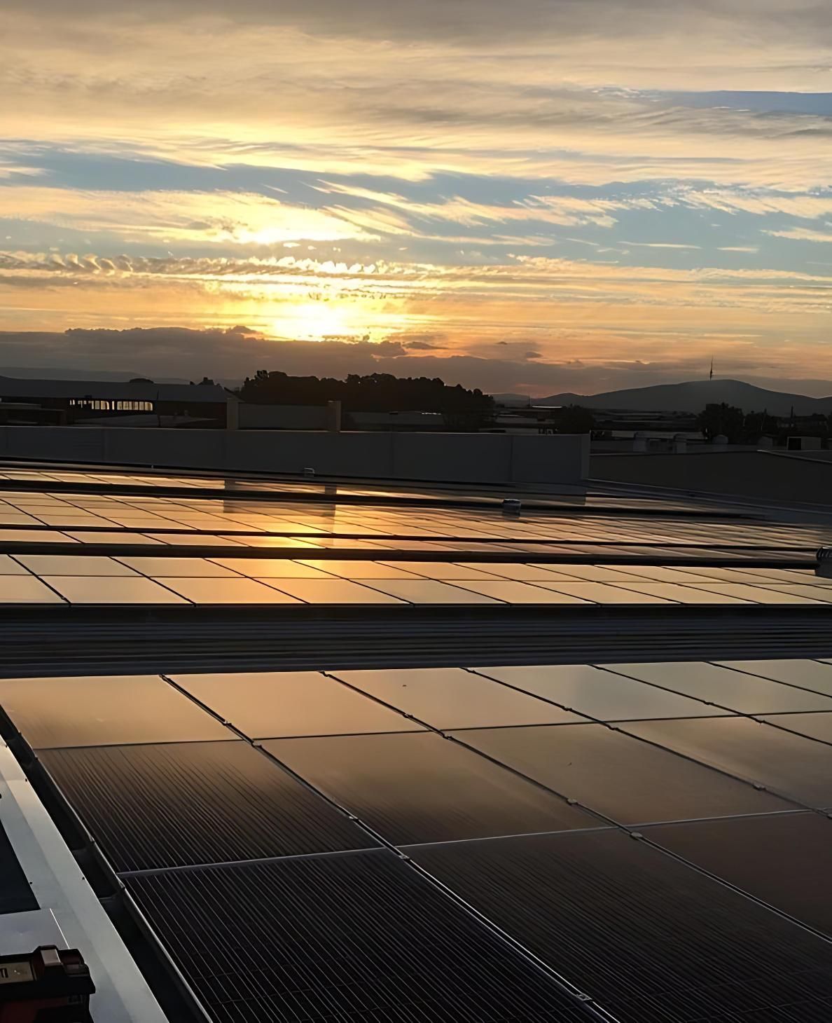 Sunset Over a Rooftop Array of Solar Panels