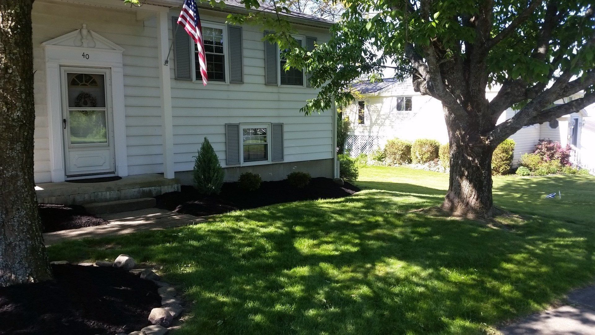 fresh shrubs and mulch in front landscaping