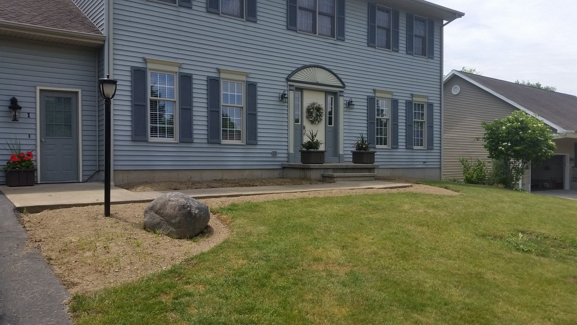 front view of landscaping on blue house