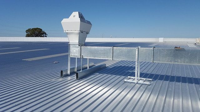 A metal roof with a ventilation system on it