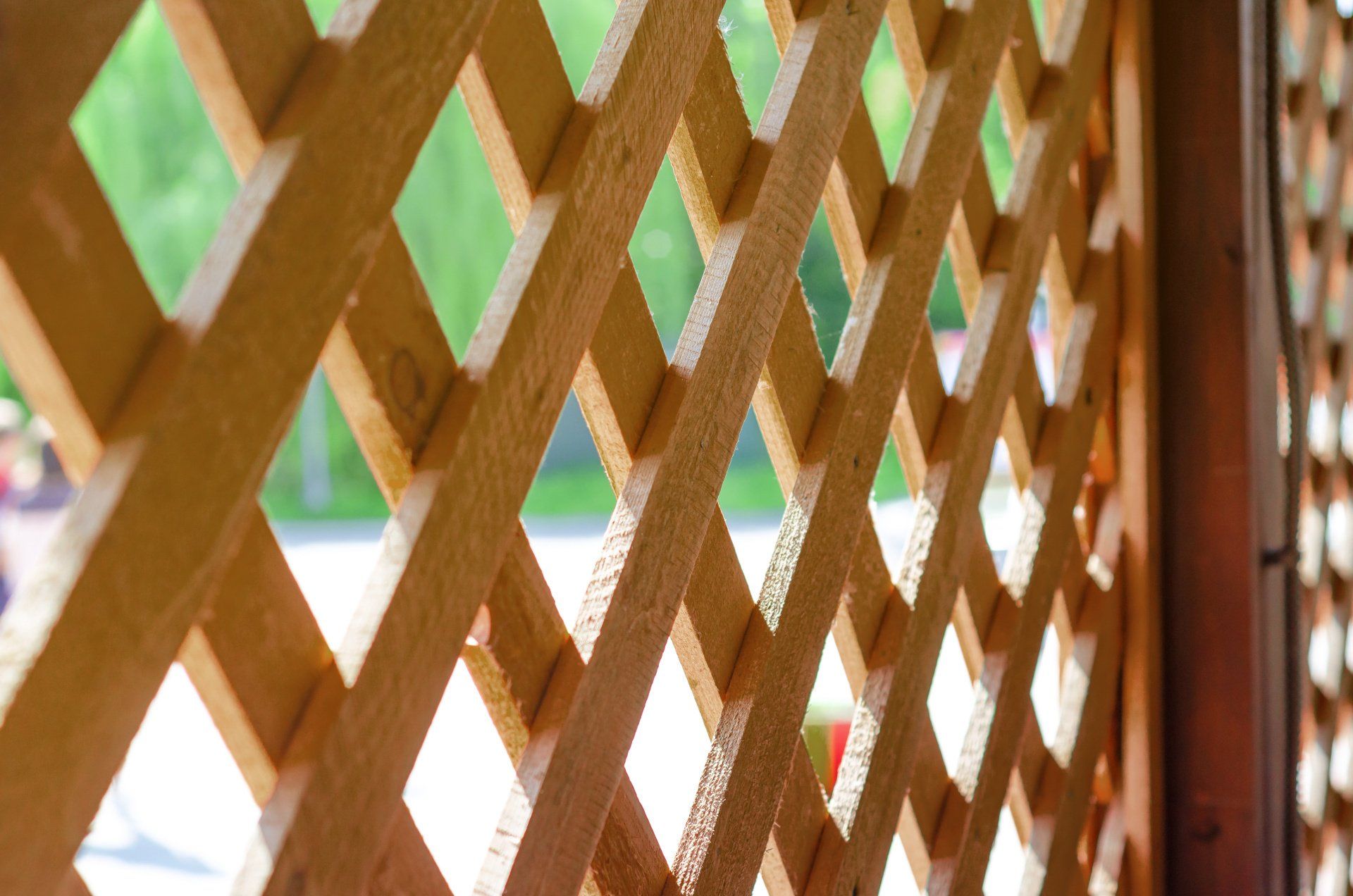 A wood lattice fence surrounding a deck