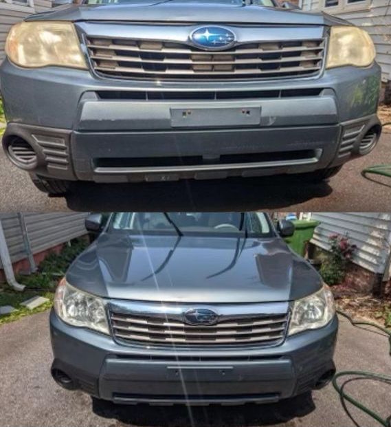 A blue subaru forester is parked in a driveway next to a house.