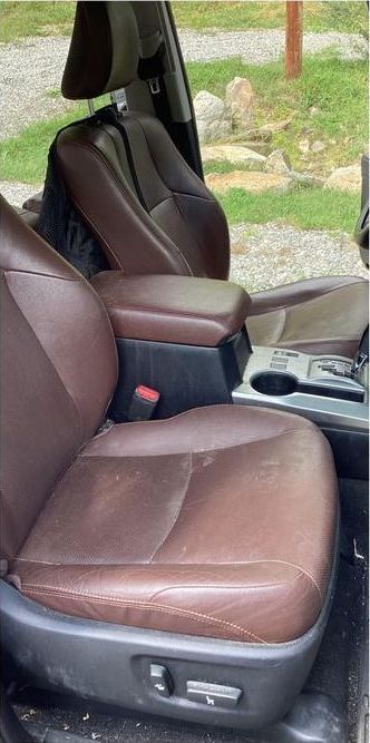 A close up of the front seats of a car.