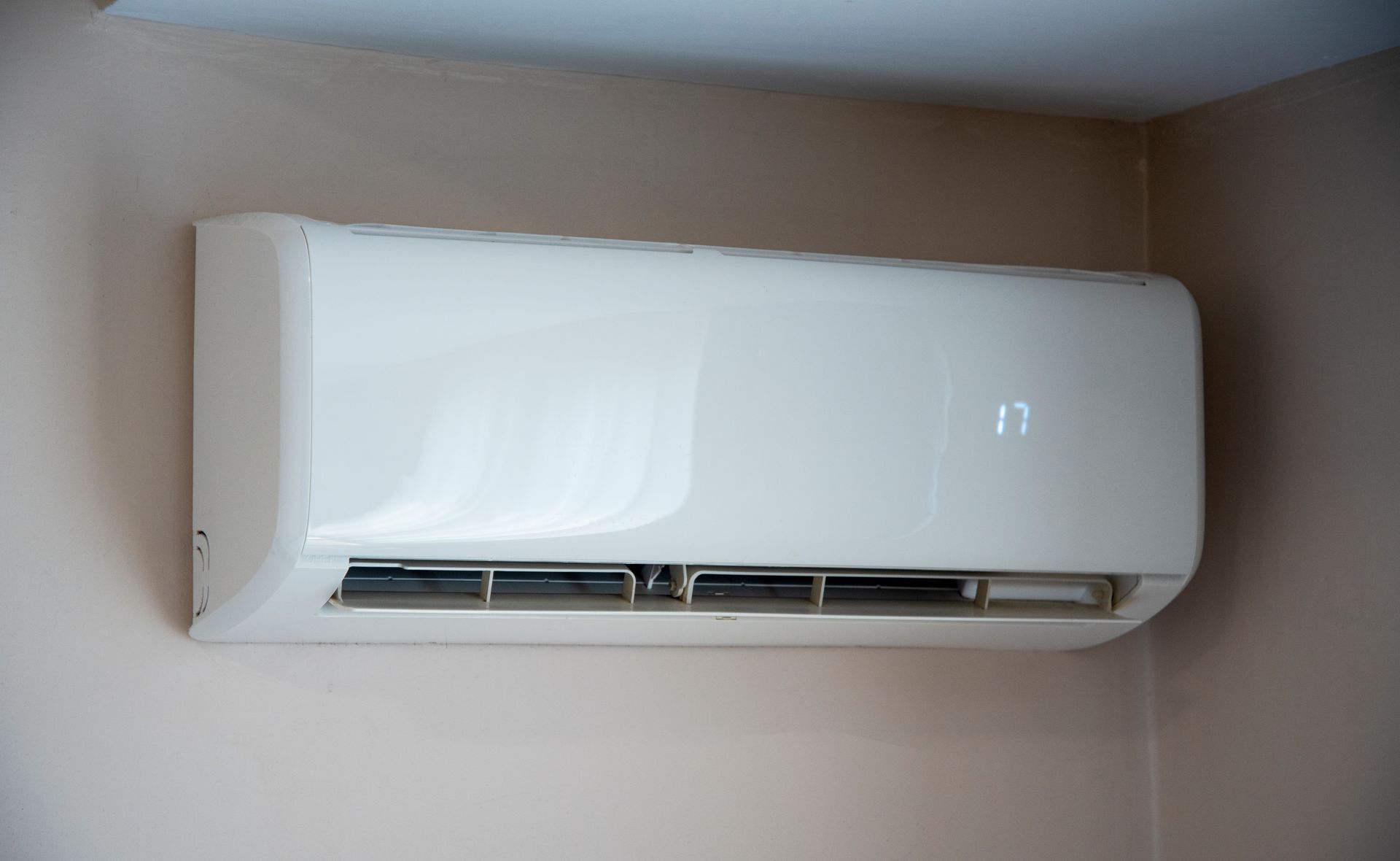 Modern living room with blue, gray, and white decor, hardwood floors, and large windows.