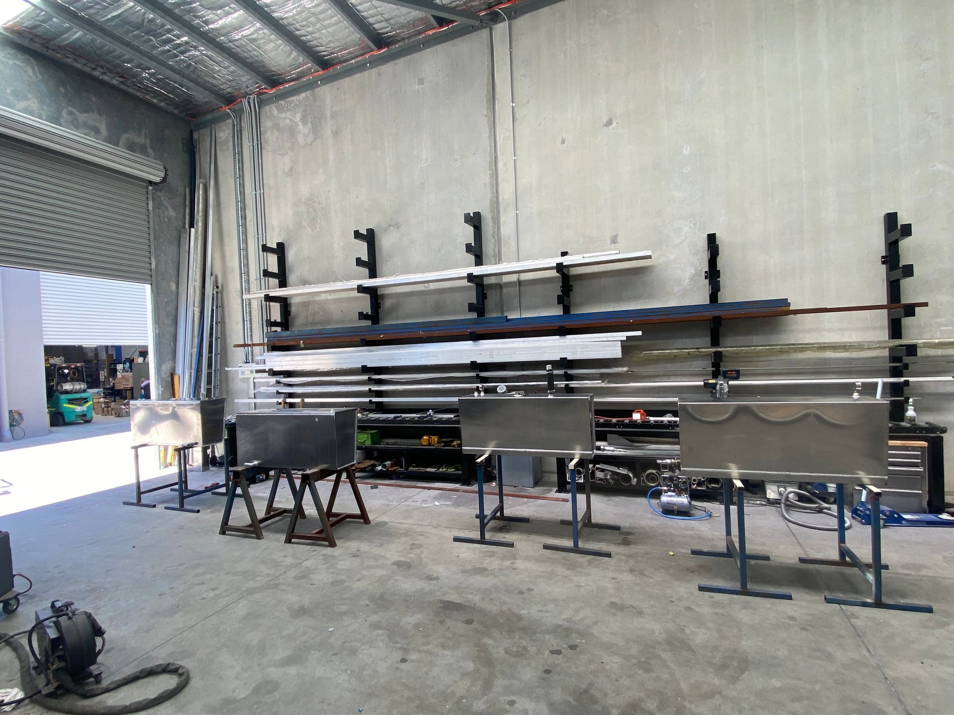 A Man is Welding a Piece of Metal in a Factory — EB Metalworks in Gosford, NSW