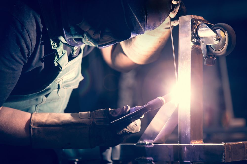 Welder in Protective Gear Working on Metal, Bright Welding Sparks, Workshop Setting — EB Metalworks in Somersby, NSW