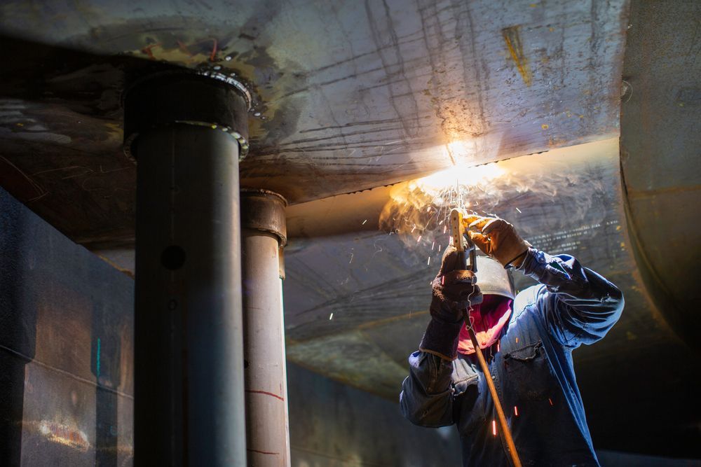 Welder in Protective Gear Working on a Large Metal Structure, Sparks Flying — EB Metalworks in Somersby, NSW