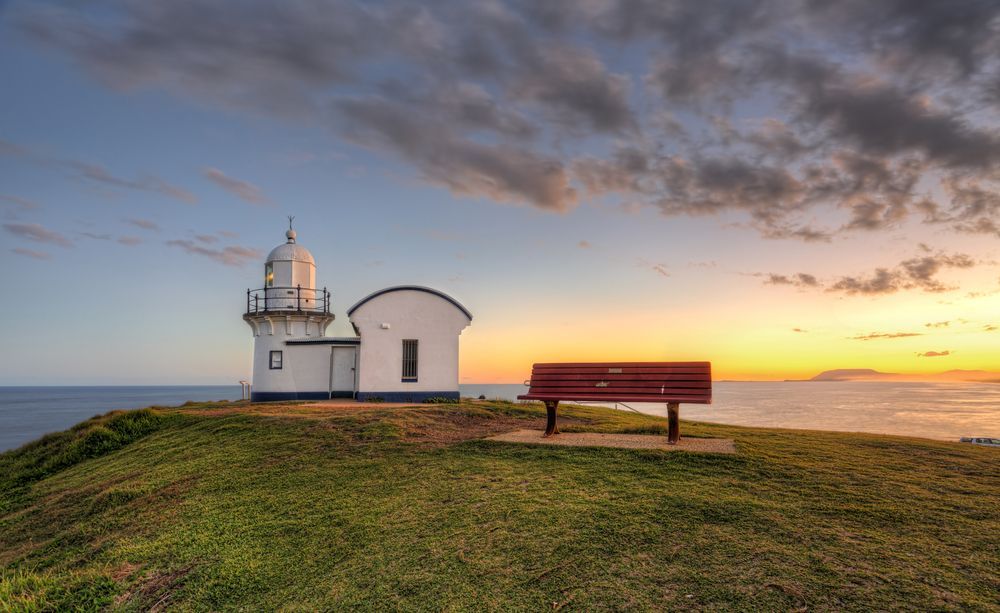 Lighthouse and Small White Building on A Grassy Bluff at Sunset — EB Metalworks in Macquarie Park, NSW